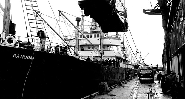 Image: black and white, loading bus onto the SS Random