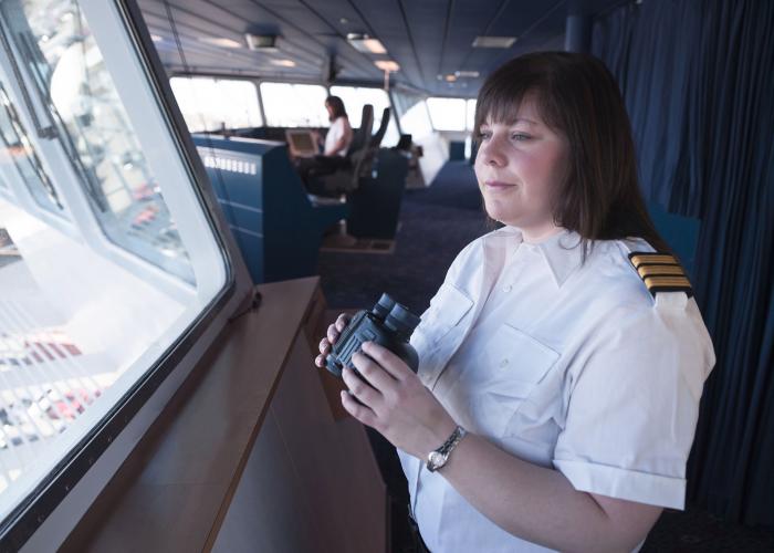 A crew member with binoculars