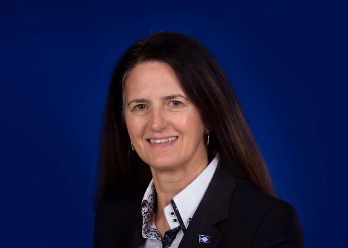 A photo of a woman in front of a blue background