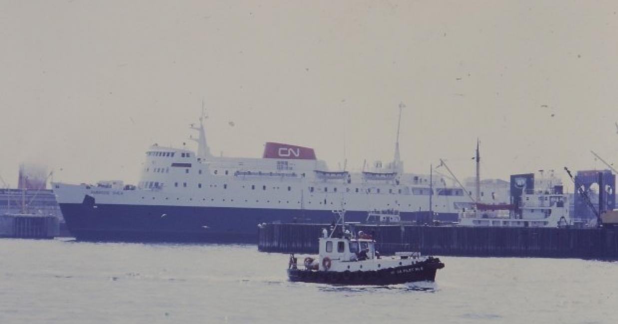 tug boat sailing away from the ambrose shea