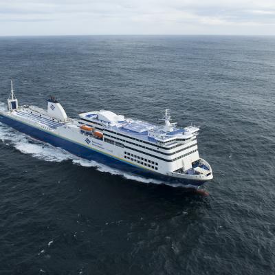 An aerial shot of a blue and white Marine Atlantic ferry as it sails in the middle of the Atlantic Ocean on a windy day.