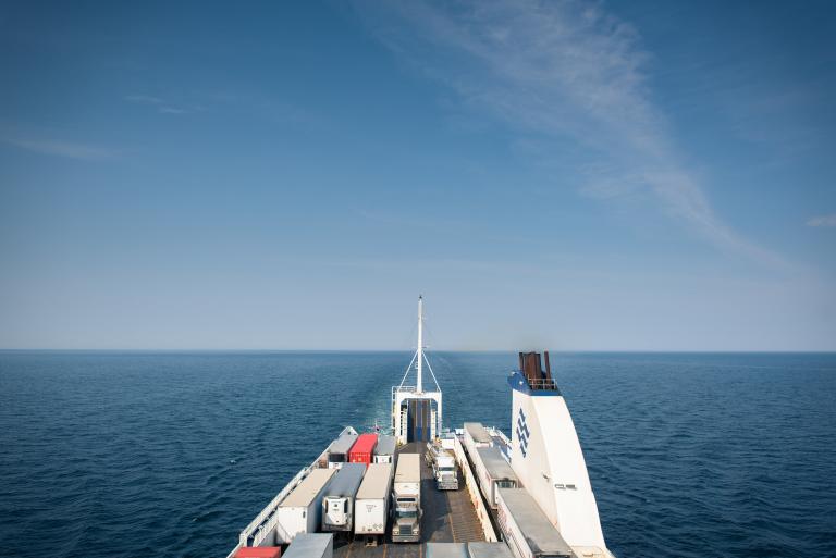 View of the ocean behind a commercial ship.