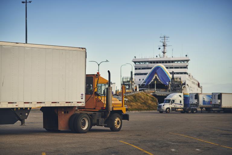 Truck driving onto ferry ramp