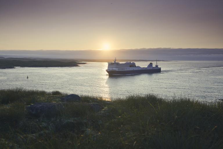 ferry sailing at sunset