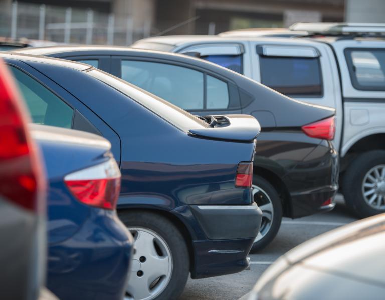 Several vehicles parked in parking lot.