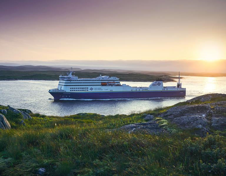 Blue Puttee ship sailing though water during sunrise