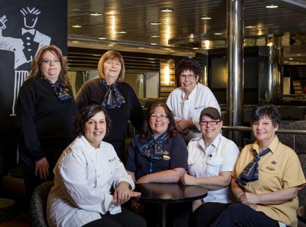 Seven female Marine Atlantic vessel staff positioned around a table