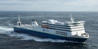 The Marine Atlantic MV Blue Puttees ferry sails the whitecaps of the Atlantic Ocean on a clear but windy day. 