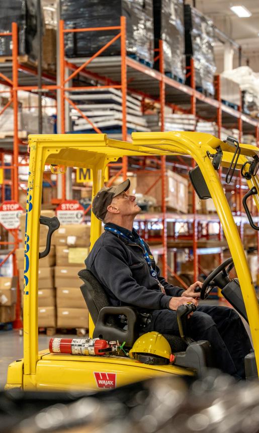 A man operating a forklift in a warehouse