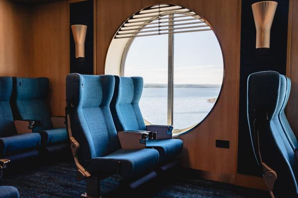 Two recliners beside a large circular window